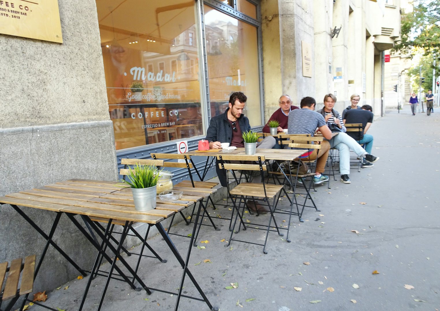 people seated outside Madal bar