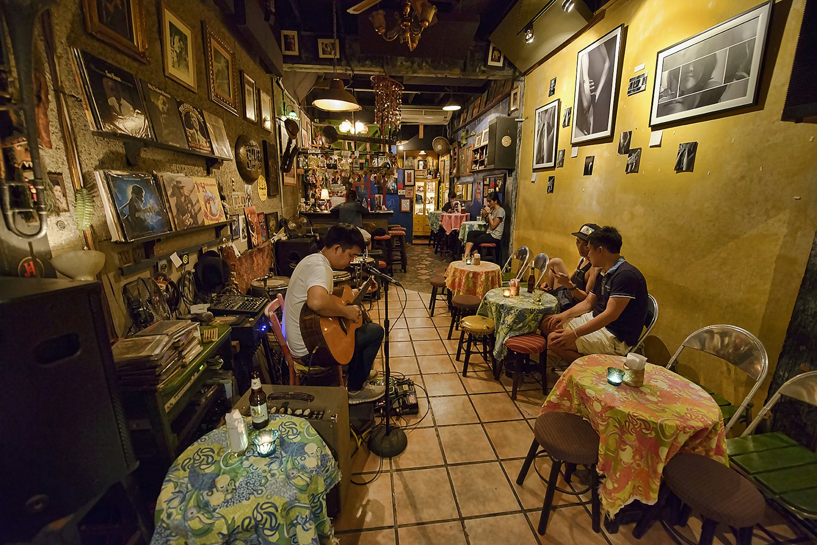 man playing guitar at Adhere the 13th Blues bar 