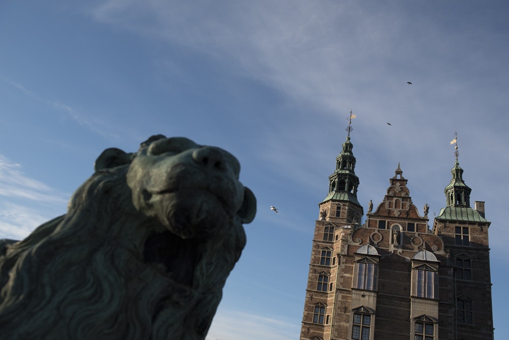 statue of a lion in front of the Rosenborg Castle in Copenhagen