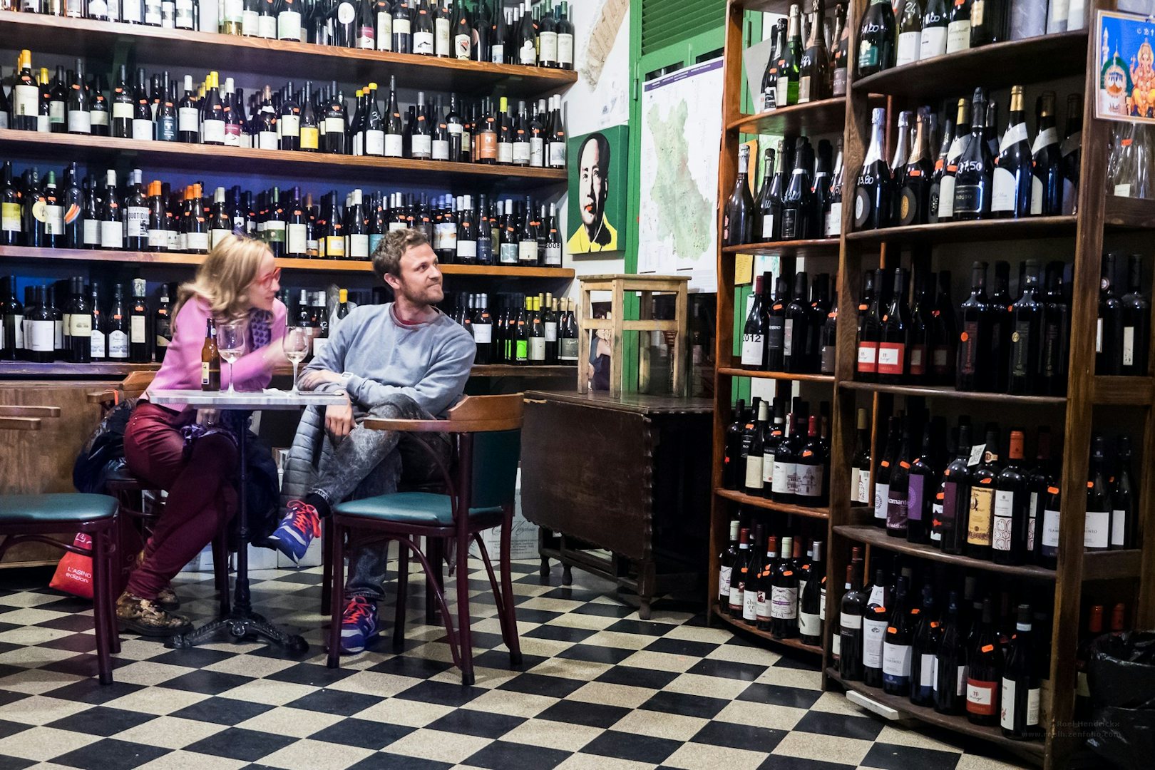 a couple sitting down at Il Vinaeitto wine bar