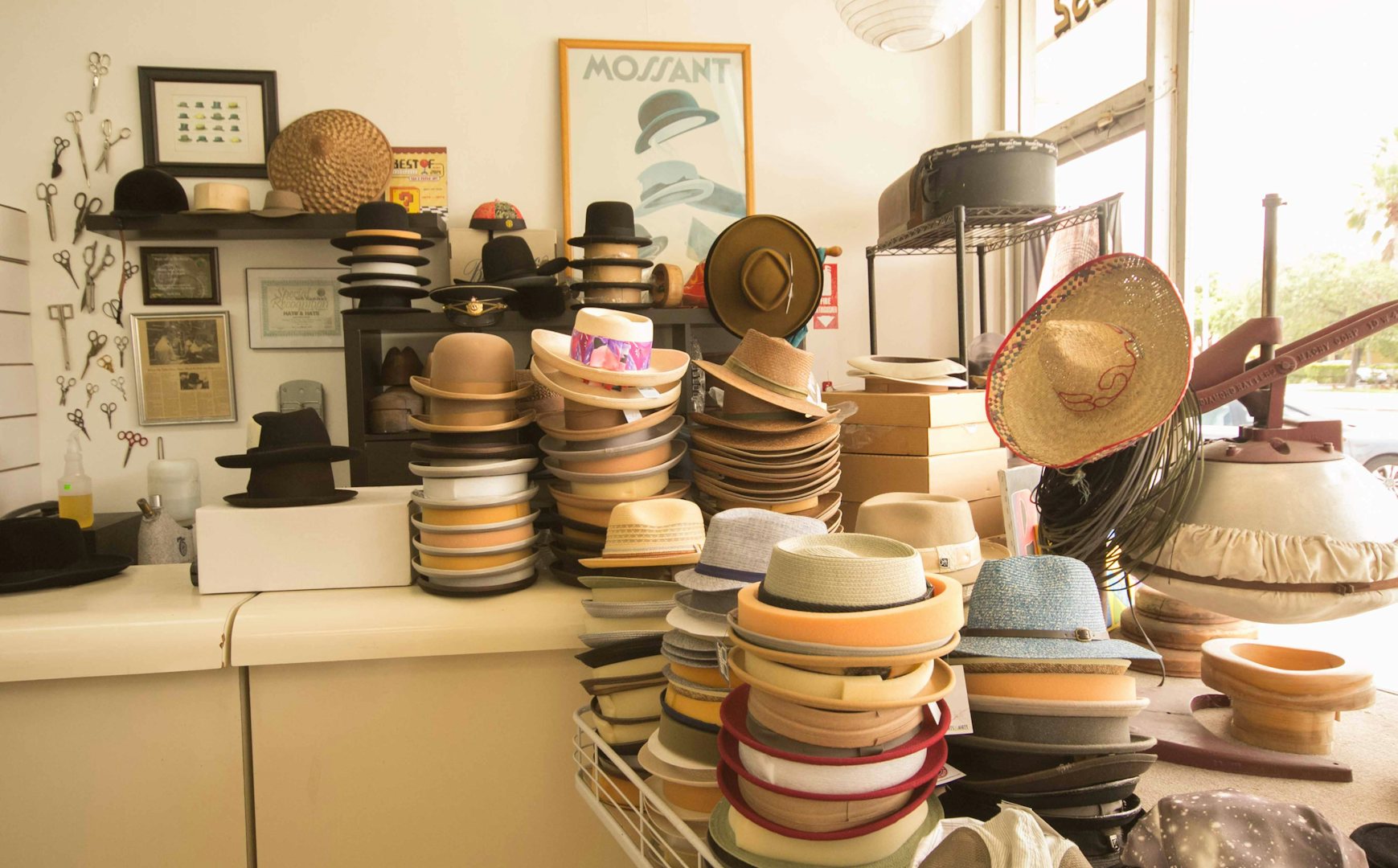 many kinds of fedoras on a pile