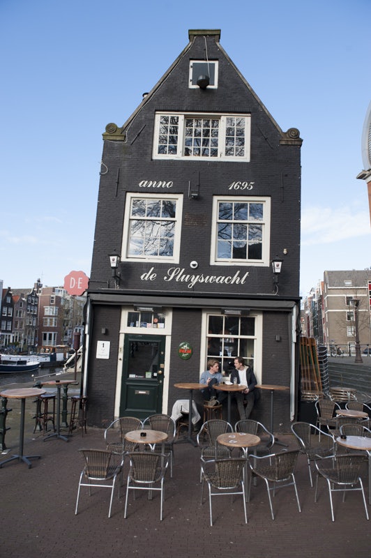 a black crooked house the Sluyswacht in Amsterdam