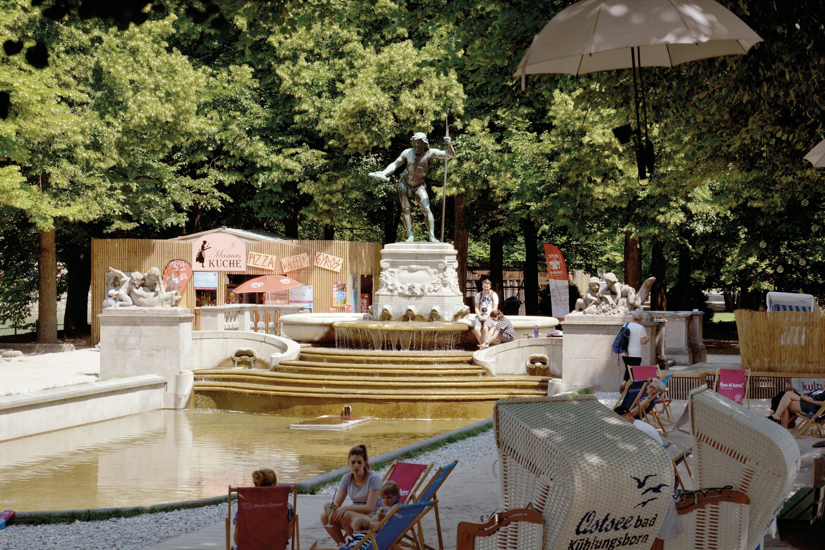 people sitting near the fountain at Kulturstrand