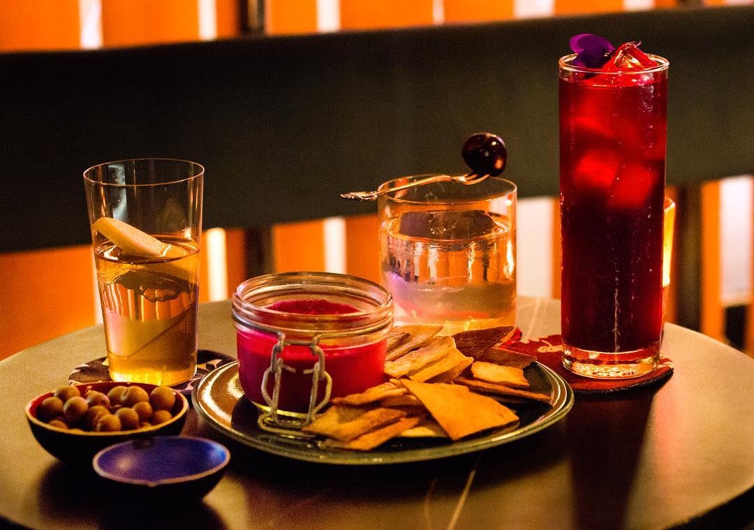 three cocktails and nachos with dipping sauce