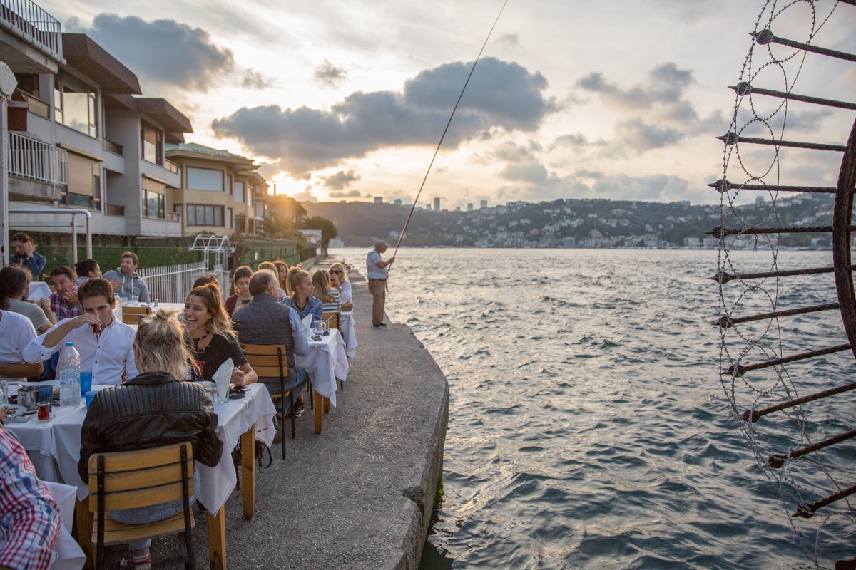 people drinking by the water at Kandilli Suna'nin Yeri