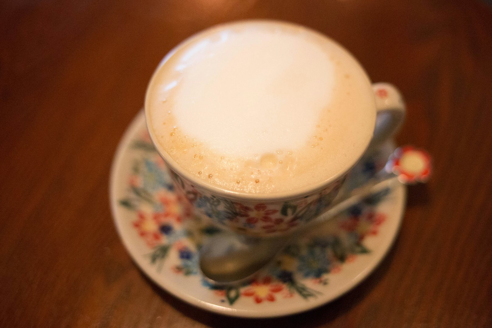 a cup of coffee with flower design