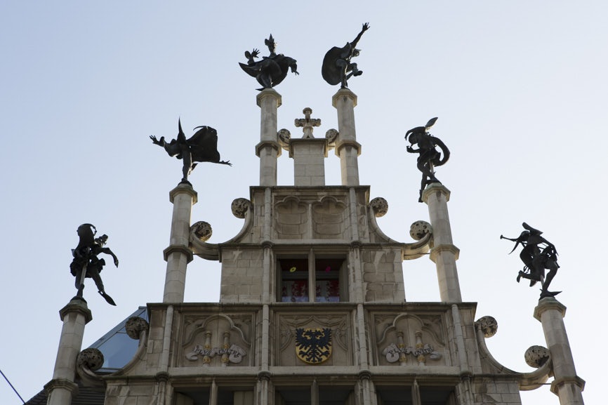 six decorative statues on top of the Masons' Guild House in Ghent