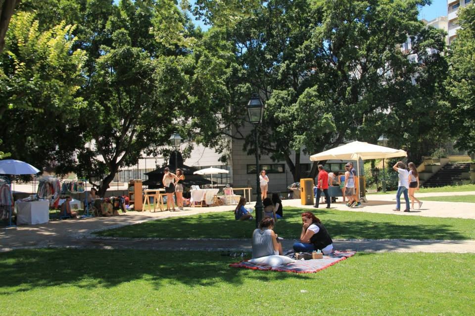 people sitting in the grass at the Mercado do Jardim