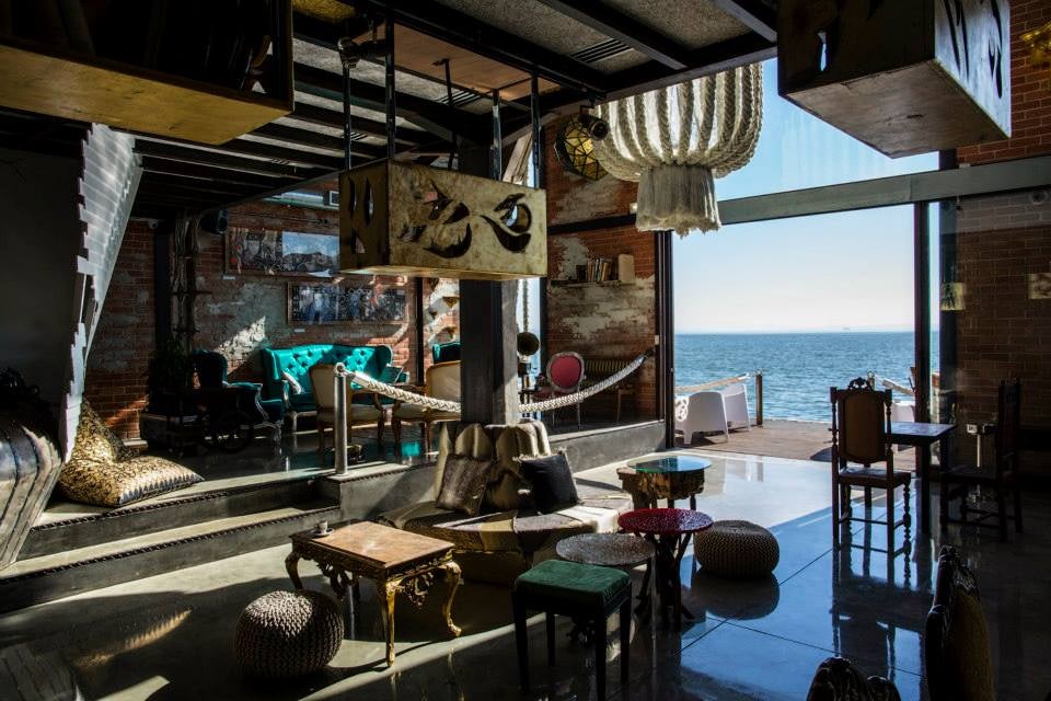 interior of Vestigius and view over the ocean in Lisbon