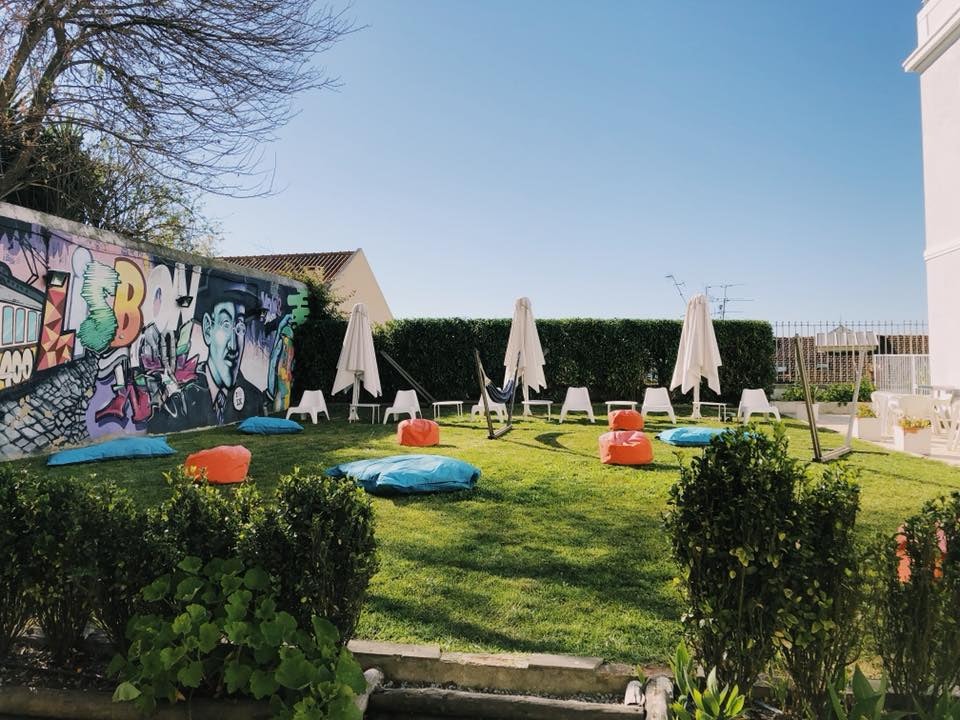 garden with bean bags and mural painting at the Lisb'on Hostel