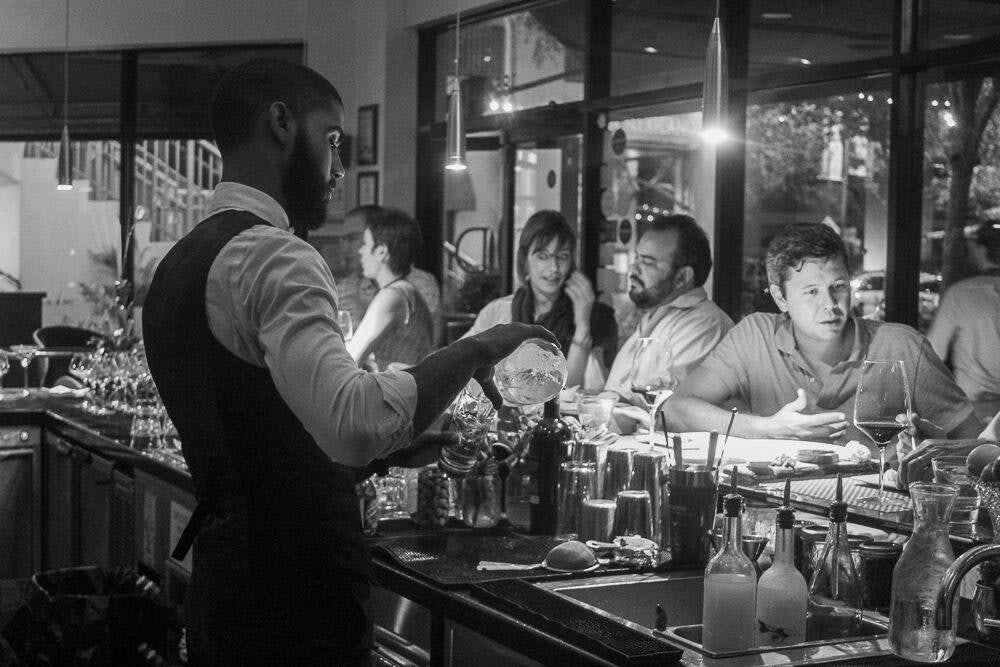 black and white picture of customers at the Toscana Divino bar