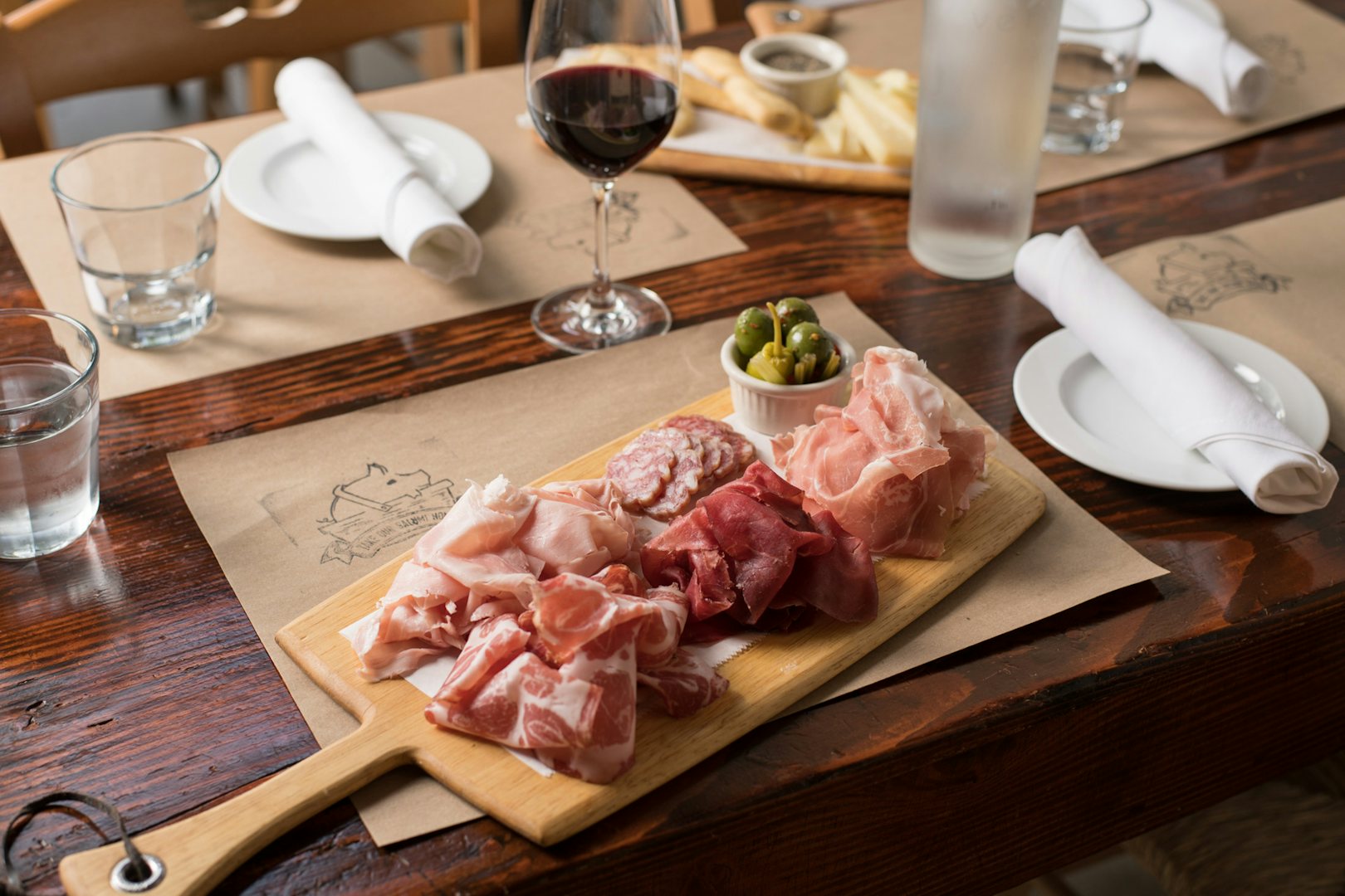 plate of cold cuts and olive and wine at the Salumeria 104