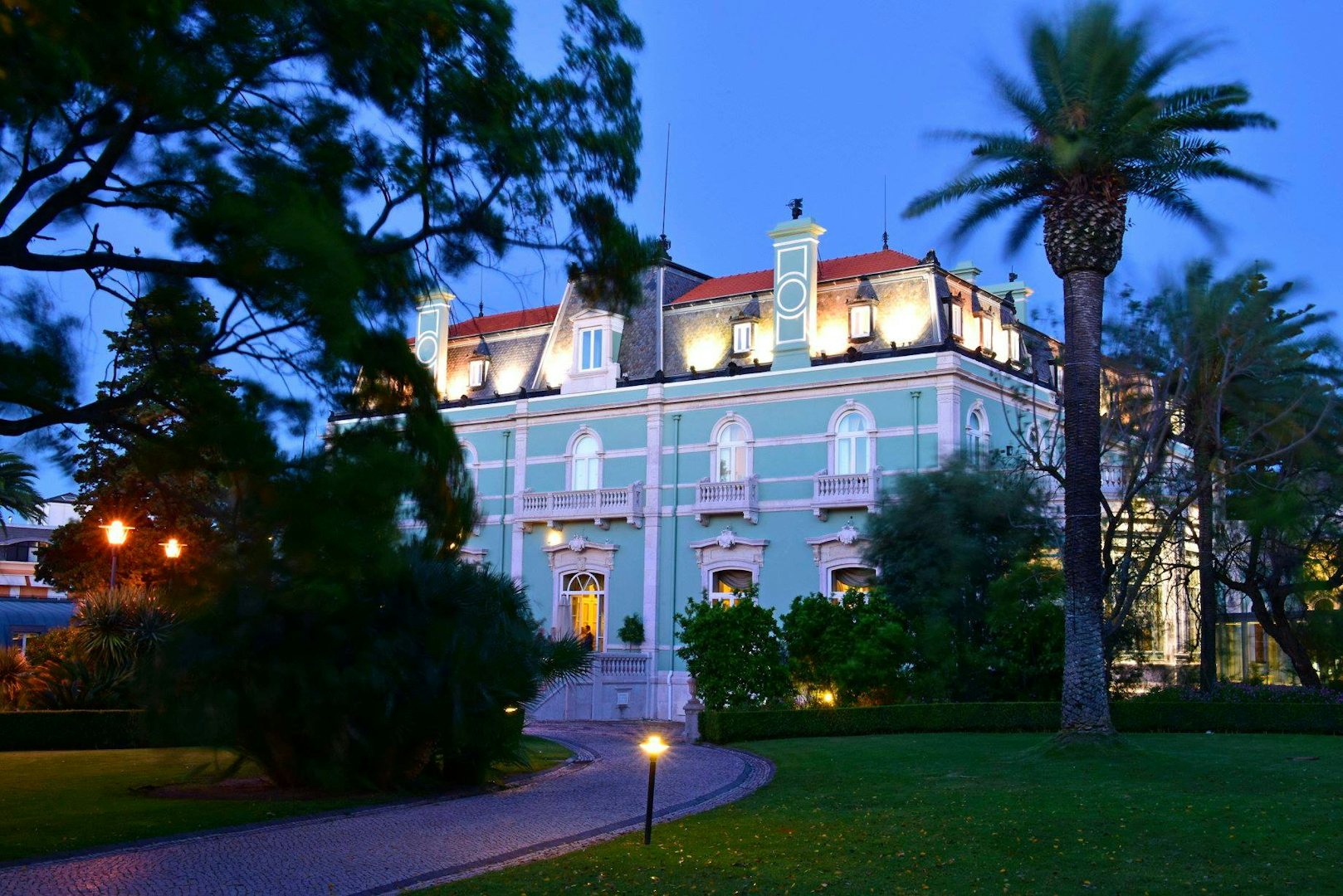 garden and bright blue exterior of the Pestana Palace