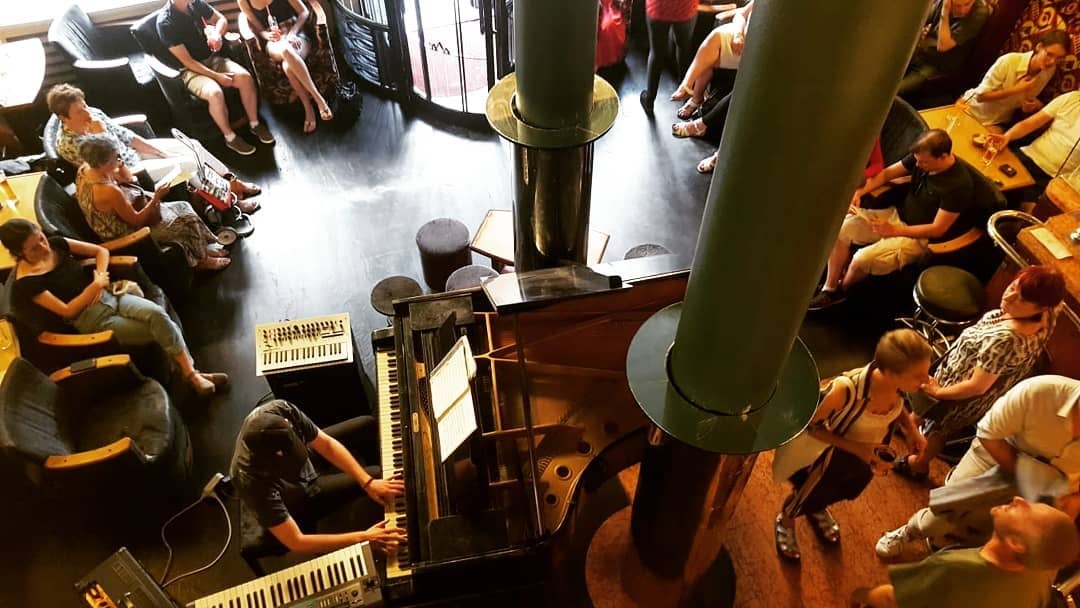 a man playing piano at L'Archiduc cafe