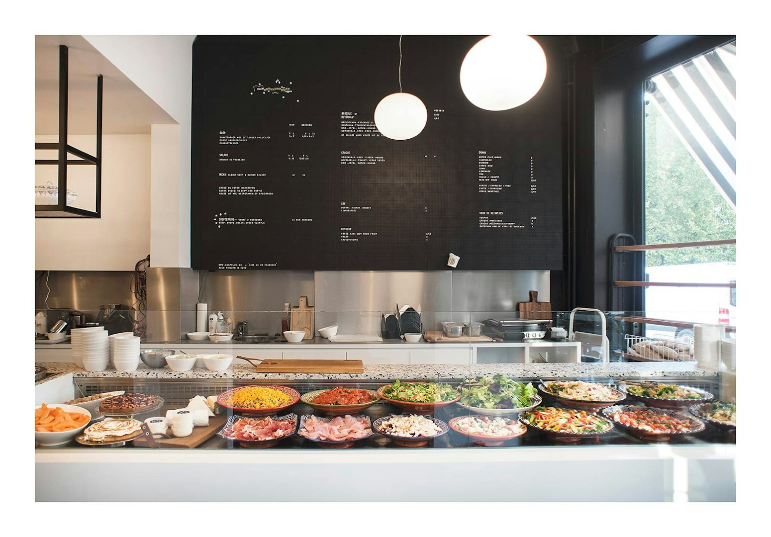 a counter full of salads at Soep+ interior