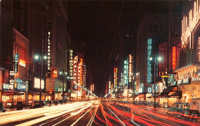 many red neon signs at the broadway theatre district