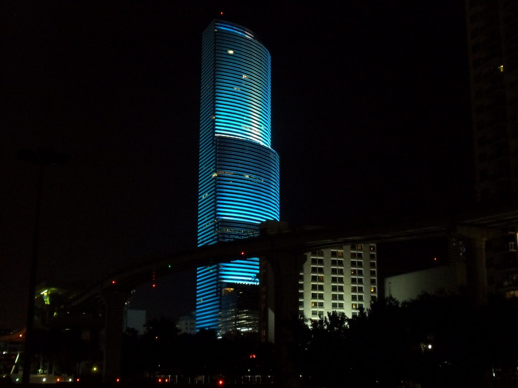 a blue lighted Miami Tower by night