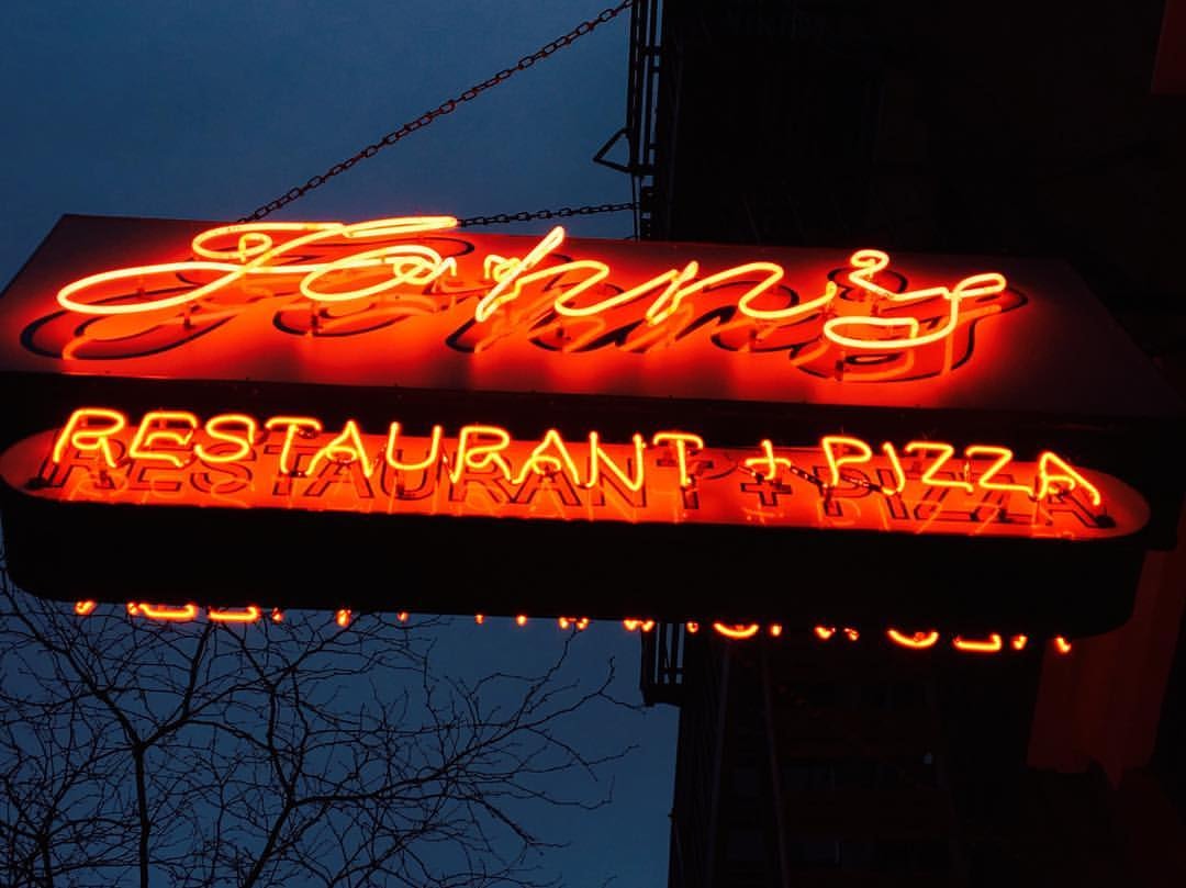 red neon sign John's of 12th Street