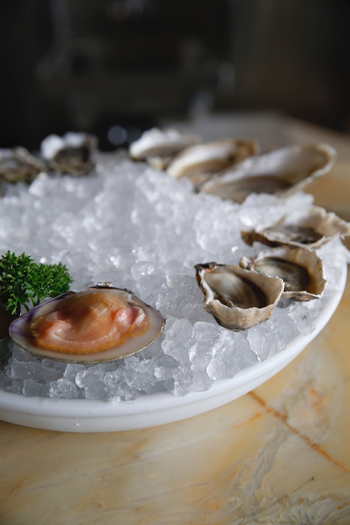 a plate of oysters on ice at the Petit Marlowe