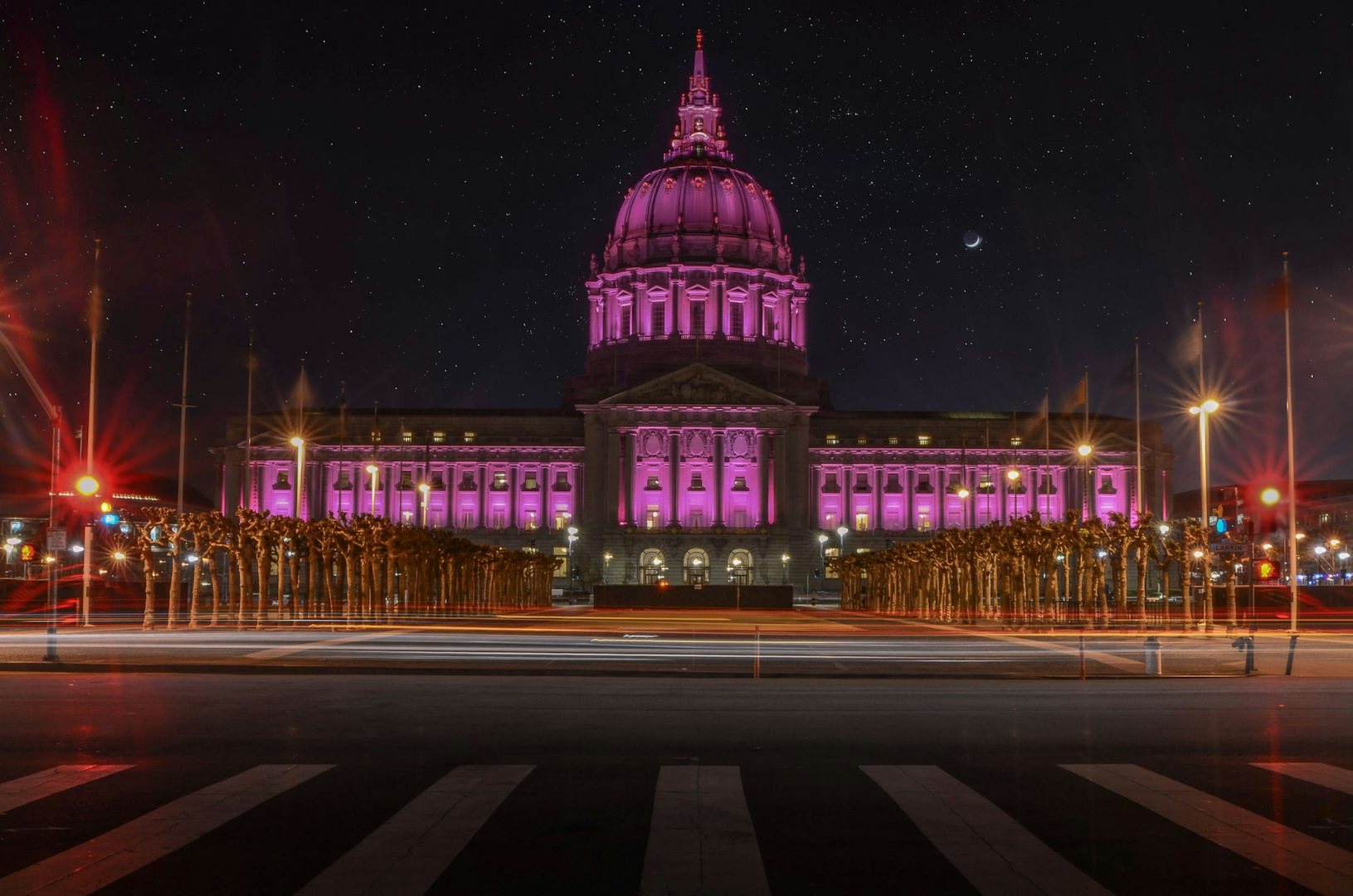 a pink-lighted San Francisco City hall