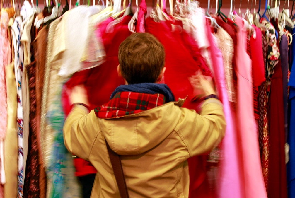 a woman shopping for vintage clothes