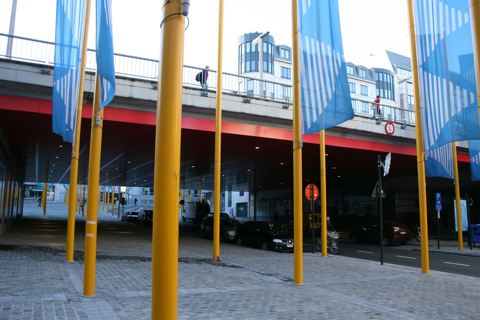 yellow and blue flagpole at Place de la Justice