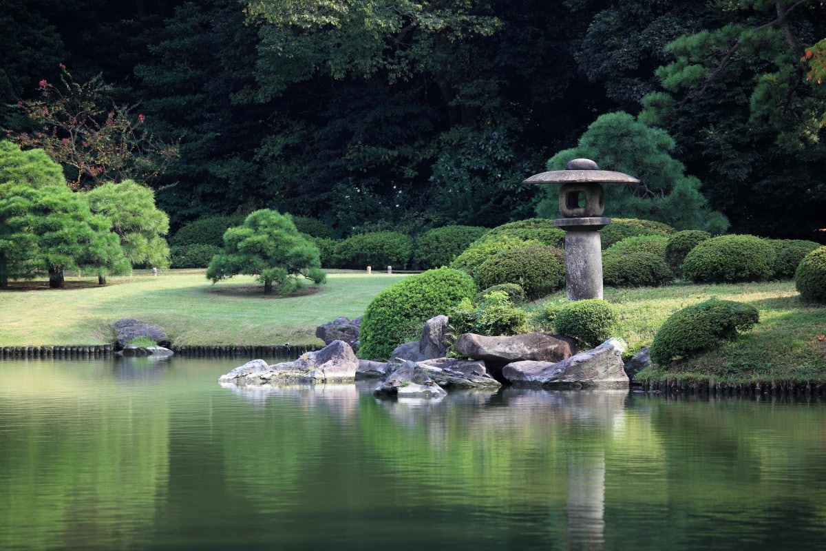 a pond and grass meadows at Rikugien Gardens in Tokyo