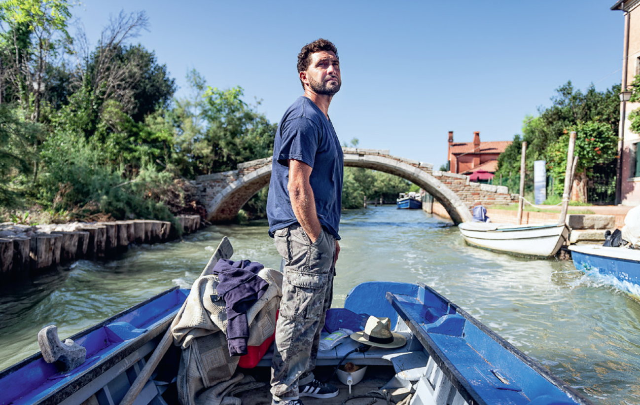 fisherman on a boat in Venice