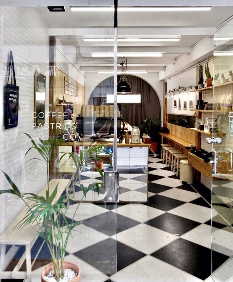 interior with black and white tiles at Syra Coffee