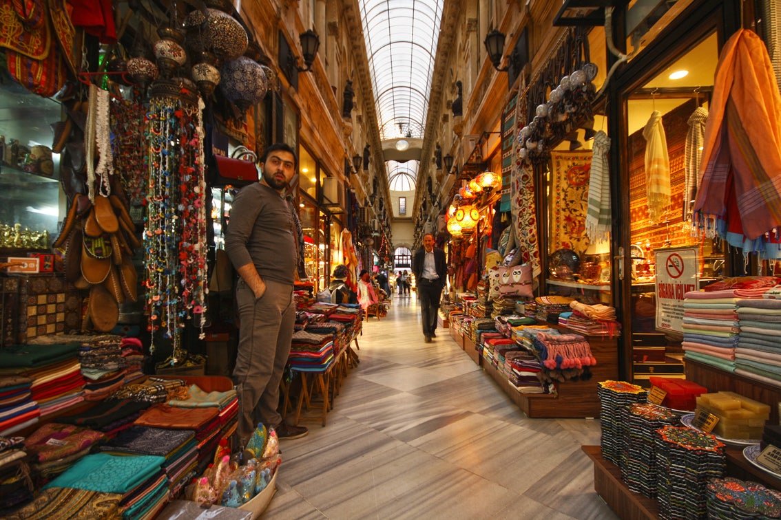 man standing in front of shop in the Avrupa Pasaji