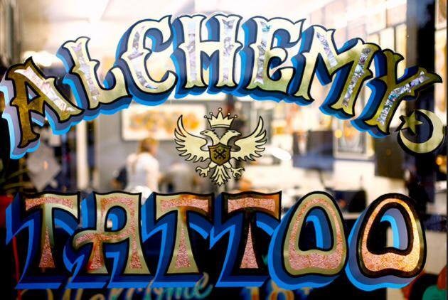 window sign of Alchemy Tattoo LA