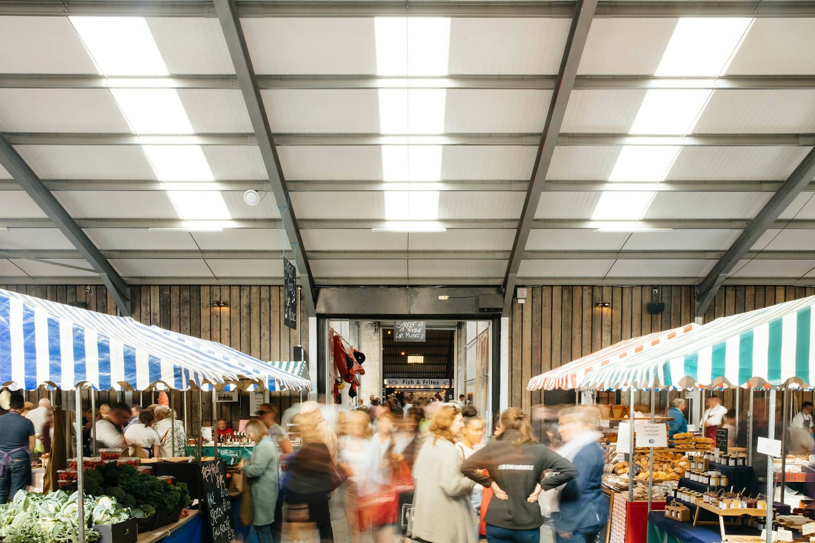 people and food stands at the Bowhouse Market in Fife