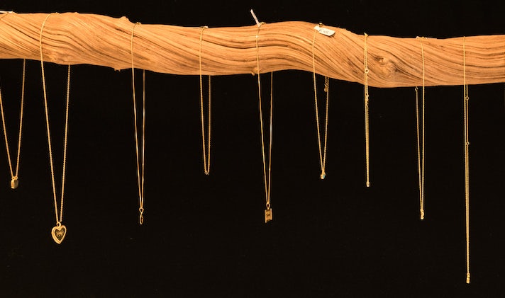 necklaces from Pepita d'Oro against a black background