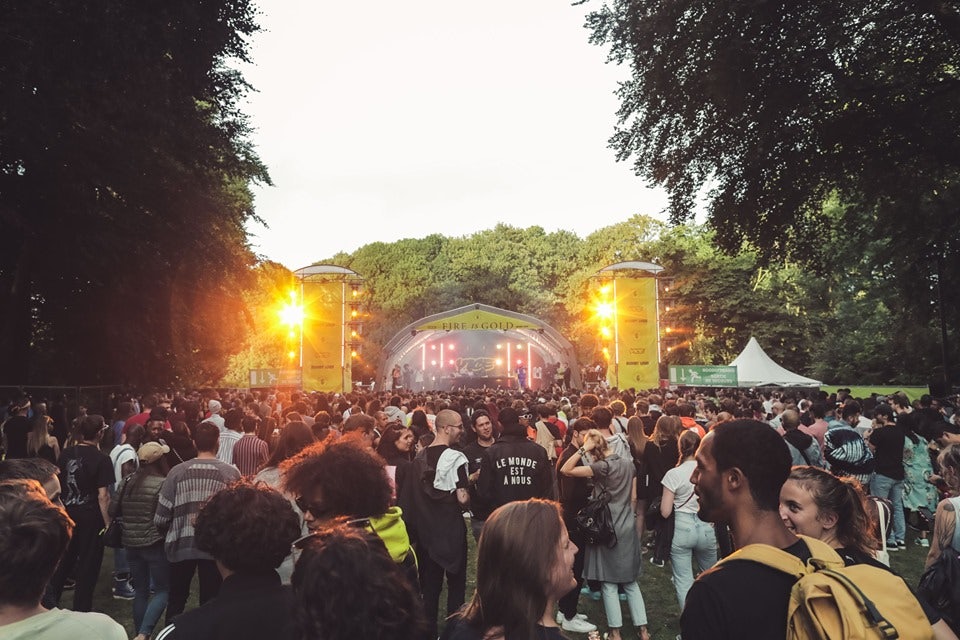 people standing in front of a stage at Fire is Gold festival