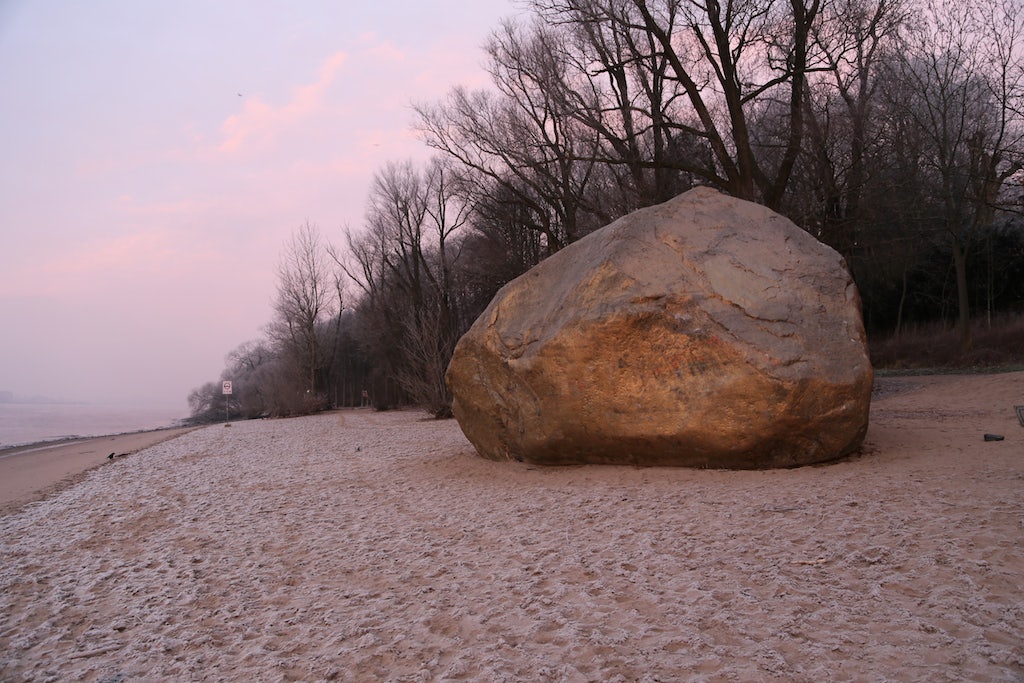 a golden rock called 'Alter Schwede' on the beach in Hamburg