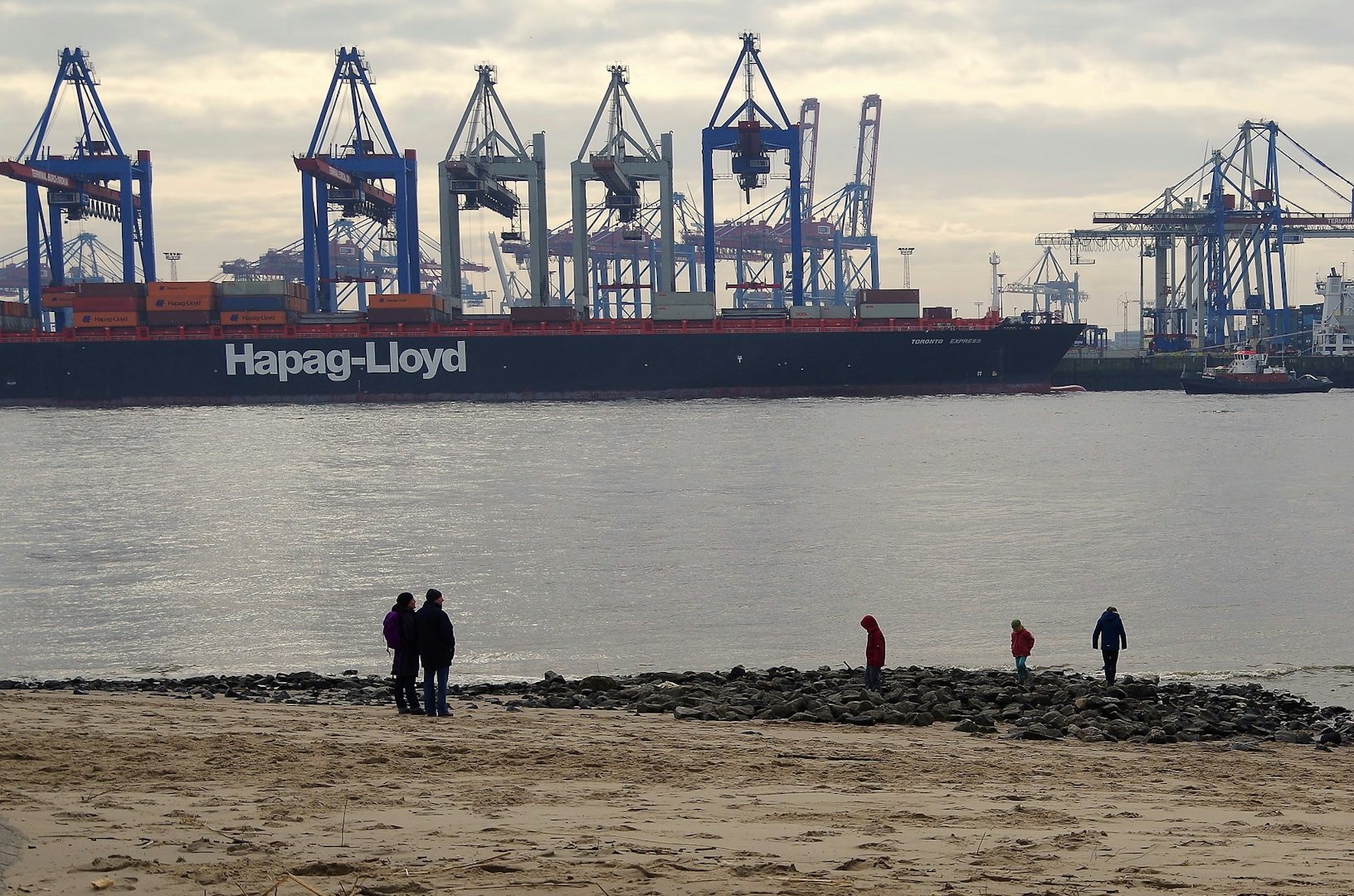 people and kids on the beach at the port of Oevelgönne in Hamburg