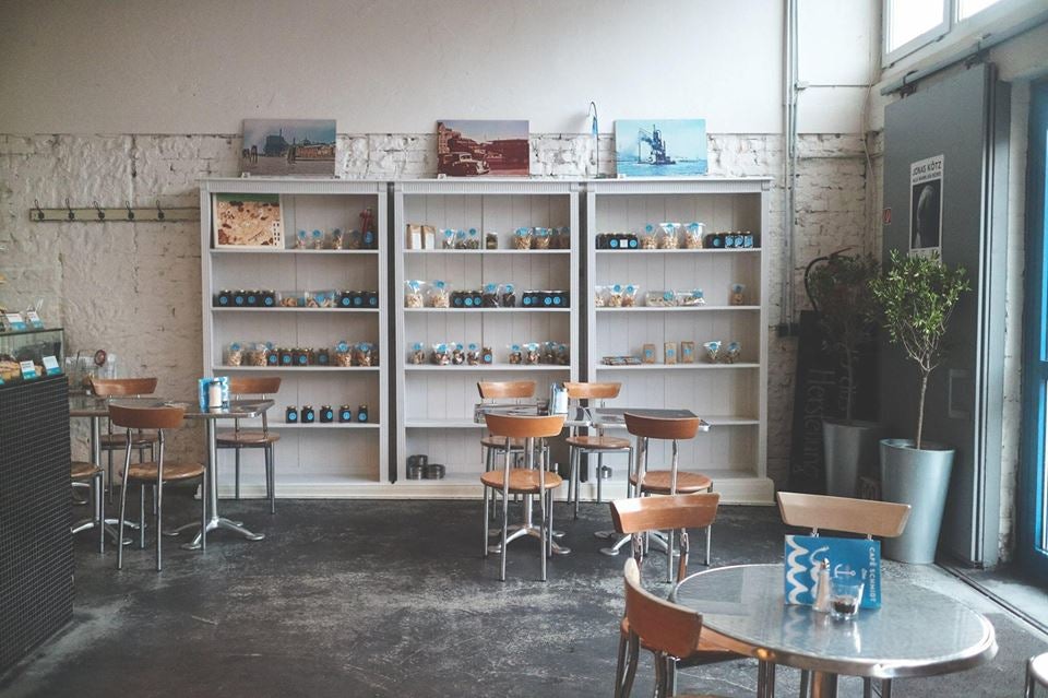 shelf with products and interior of brunch bar Café Schmidt Elbe