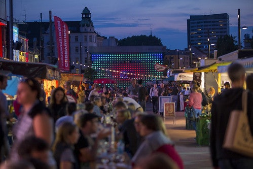 people eating at tables at the St. Pauli Night Market