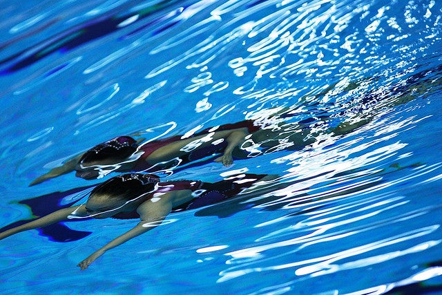 two Japanese girls swimming under water