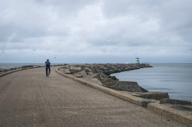 a man cycling on the Pier Head in Scheveningen