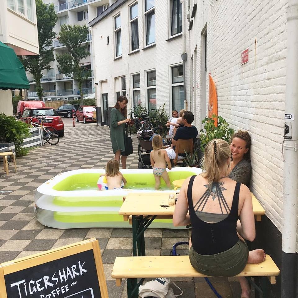 people and children outside Tigershark coffee bar in the Hague