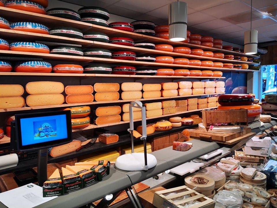 a wall full of cheese rolls at Kalkman store in The Hague