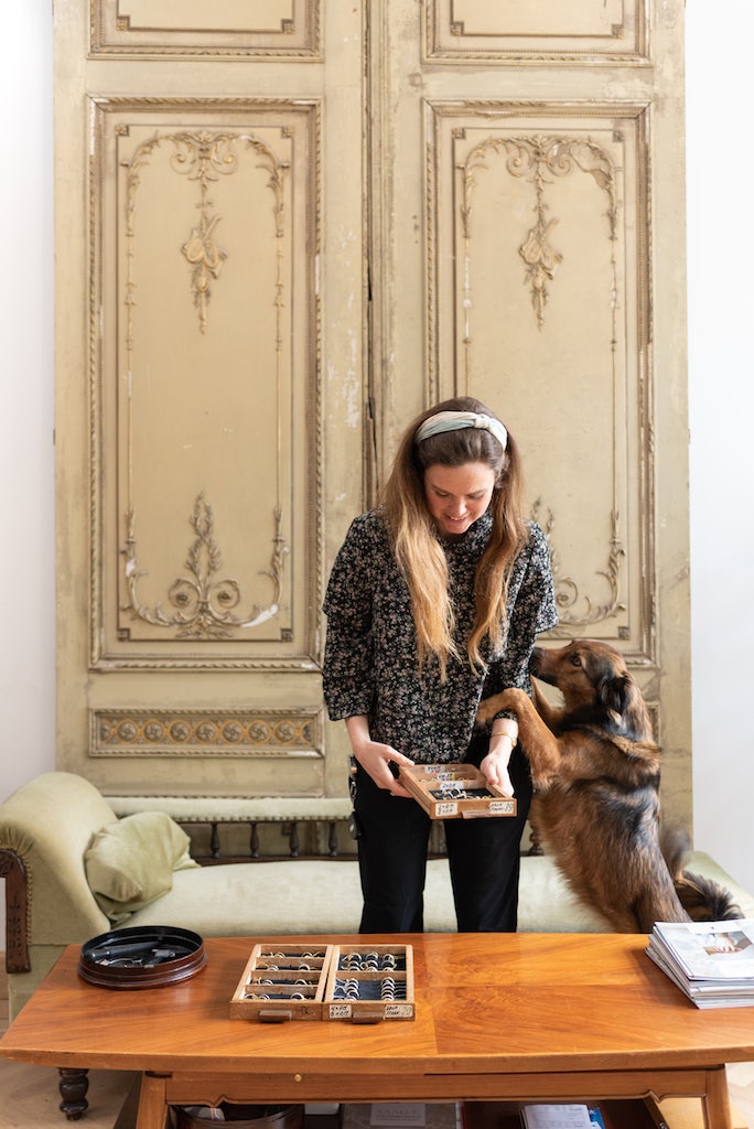 Liesbeth Busman with her dog at her jewellery shop in The Hague