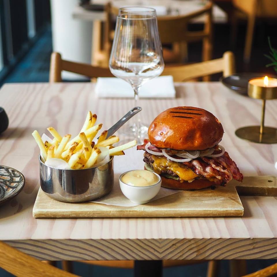 hamburger and fries on the table at NOI by Nobis restaurant