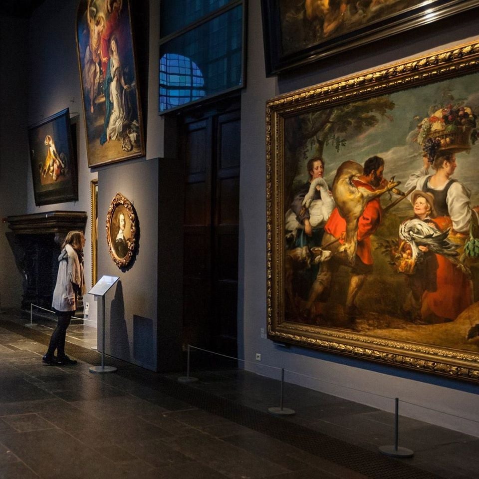 a woman admiring paintings at the Rubenshuis museum in Antwerp