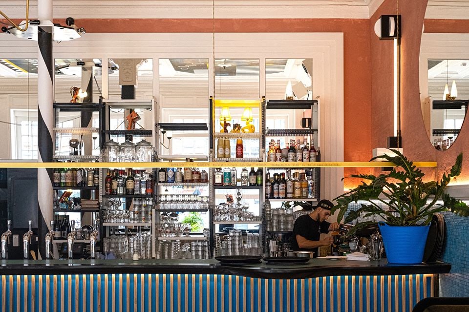 Bartender and bar at Café Flora in Brussels