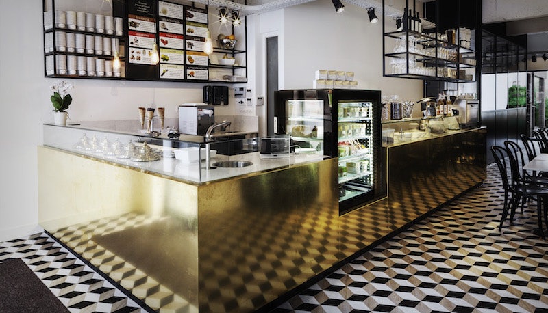 Cremerie Germaine interior with optical tiles and golden counter
