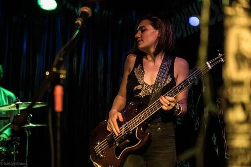 woman playing guitar at the Bovine Sex Club