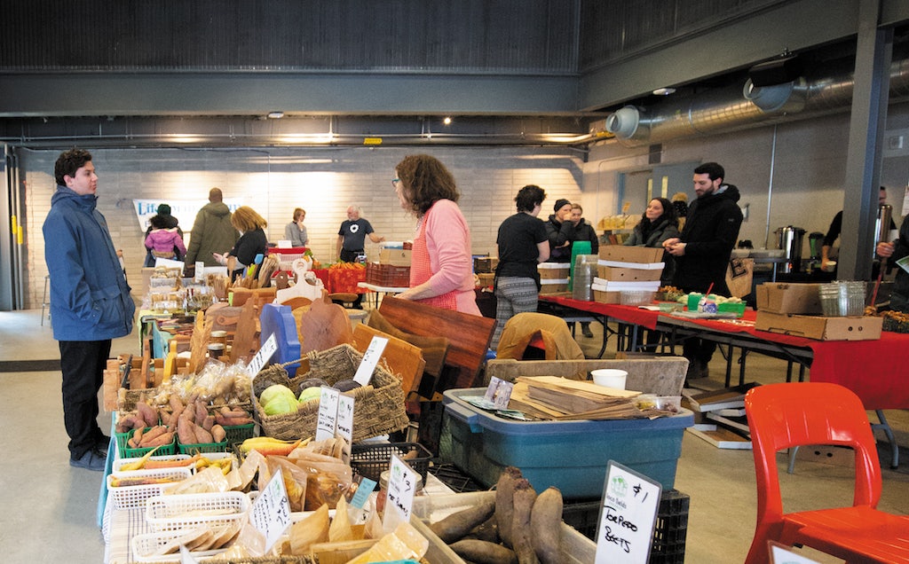 people buying groceries at the Evergreen Brick Work's farmer market