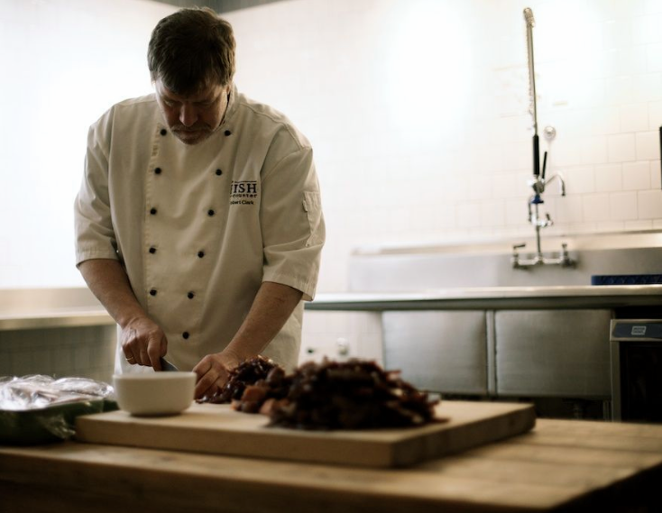 chef preparing fish at the Fish Counter